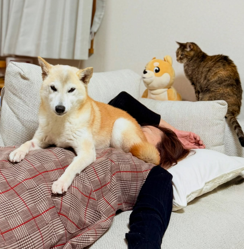 Neiro at home with her family and cat